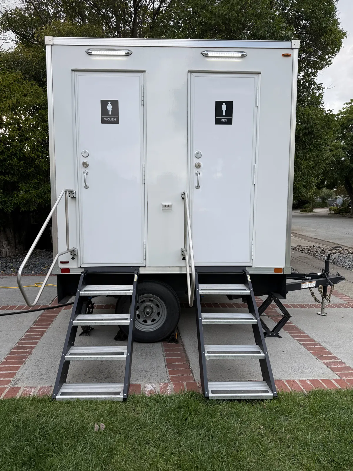 A Pro Portable Restrooms luxury restroom trailer staged on an estate lawn for a wedding