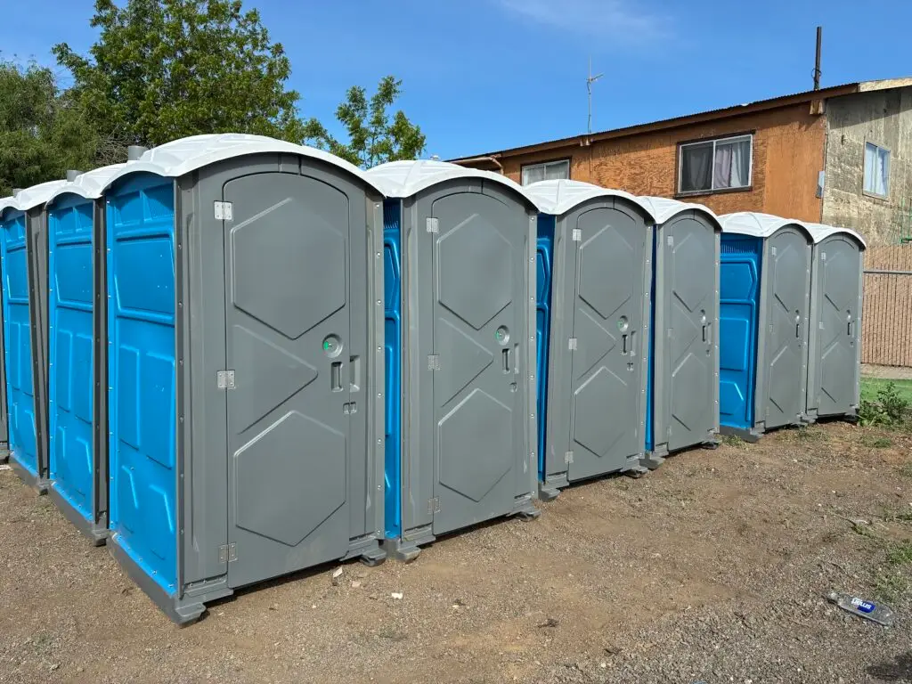 A line of clean Pro Portable Restrooms portable toilet units lined up at a Bay Area job site